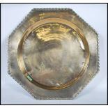 An early 20th Century Persian Islamic brass centrepiece dish of octagonal form having a central