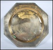 An early 20th Century Persian Islamic brass centrepiece dish of octagonal form having a central