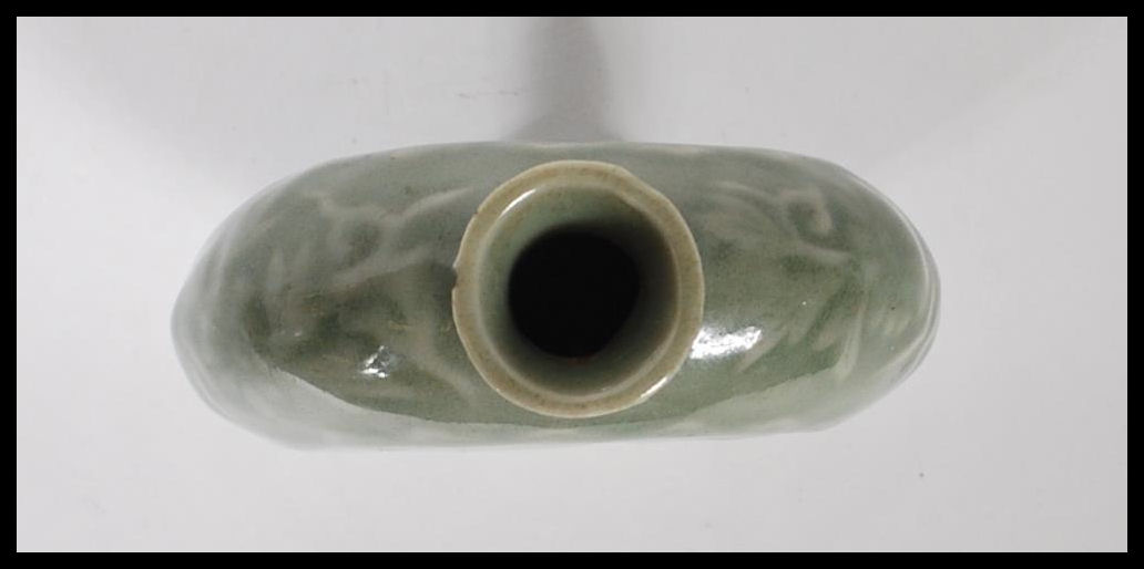 A 19th Century Chinese ceramic bottle / moon flask having a green glaze finish with floral relief - Image 6 of 7