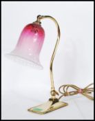 A vintage mid 20th Century brass adjustable swan neck desk lamp raised on a rectangular base with
