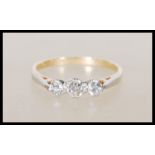 A 18ct yellow gold and platinum three stone diamond ring of approx 25pts. Marked for 18ct gold and