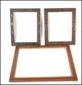 A 19th Century maple wood picture frame having gilt centre together with two carved mahogany