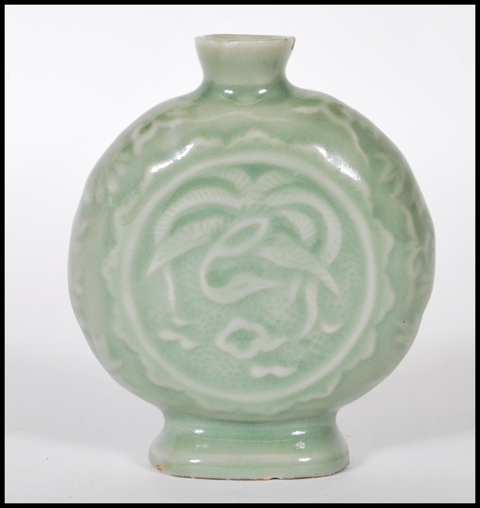 A 19th Century Chinese ceramic bottle / moon flask having a green glaze finish with floral relief - Image 4 of 7