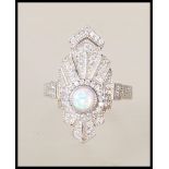 A stamped 925 silver and cz ladies Art Deco style dress ring having a central opal panel with cz's