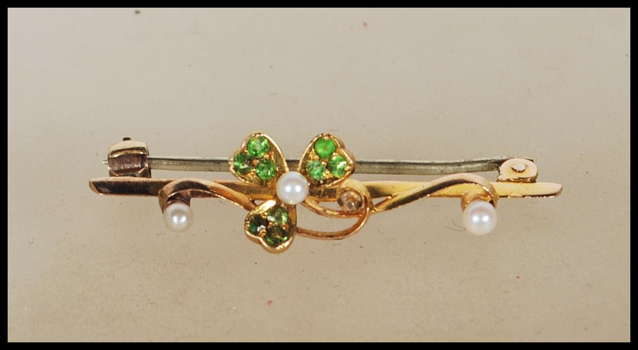 A 15ct yellow gold wirework brooch having central decoration in the form of a clover with each of