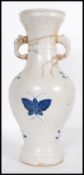 A 20th Century Chinese large vase having blue and white decoration of butterflies with twin elephant