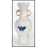 A 20th Century Chinese large vase having blue and white decoration of butterflies with twin elephant