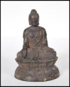 A 19th Century cast bronze figurine of a mandalay style Buddha depicted seated in the lotus position