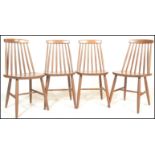 A group of four vintage mid 20th Century Ercol style spindle back dining chairs, raised on turned