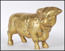 A 20th Century heavy brass figure in the form of a bull having a textured moulded details.