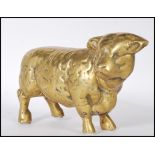 A 20th Century heavy brass figure in the form of a bull having a textured moulded details.