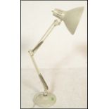 A vintage retro 20th Century 1001 Lamps anglepoise lamp raised on a circular base with conical