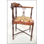 An early 20th Century Edwardian mahogany and marquetry inlaid corner chair / armchair being raised