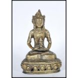 A 20th Century brass figure of a Indian deity seated crossed legged on lotus throne. The deity shown