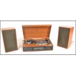 A retro mid 20th Century teak case Dynatron music center having inbuilt amplifier and tuner. The