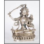 A 20th Century Tibetan white brass figure of Bodhisattva Manjushri seated crossed legged on a