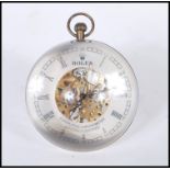 An unusual Roman style fish eyeball clock having a central open skeleton movement with Roman numeral