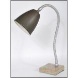 A retro 20th Century table desk lamp having dark green enamel pendant shade on a chrome gooseneck