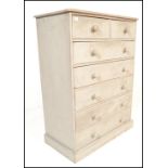 A 20th Century painted pine chest of two over five drawers, the flared top over two short drawers