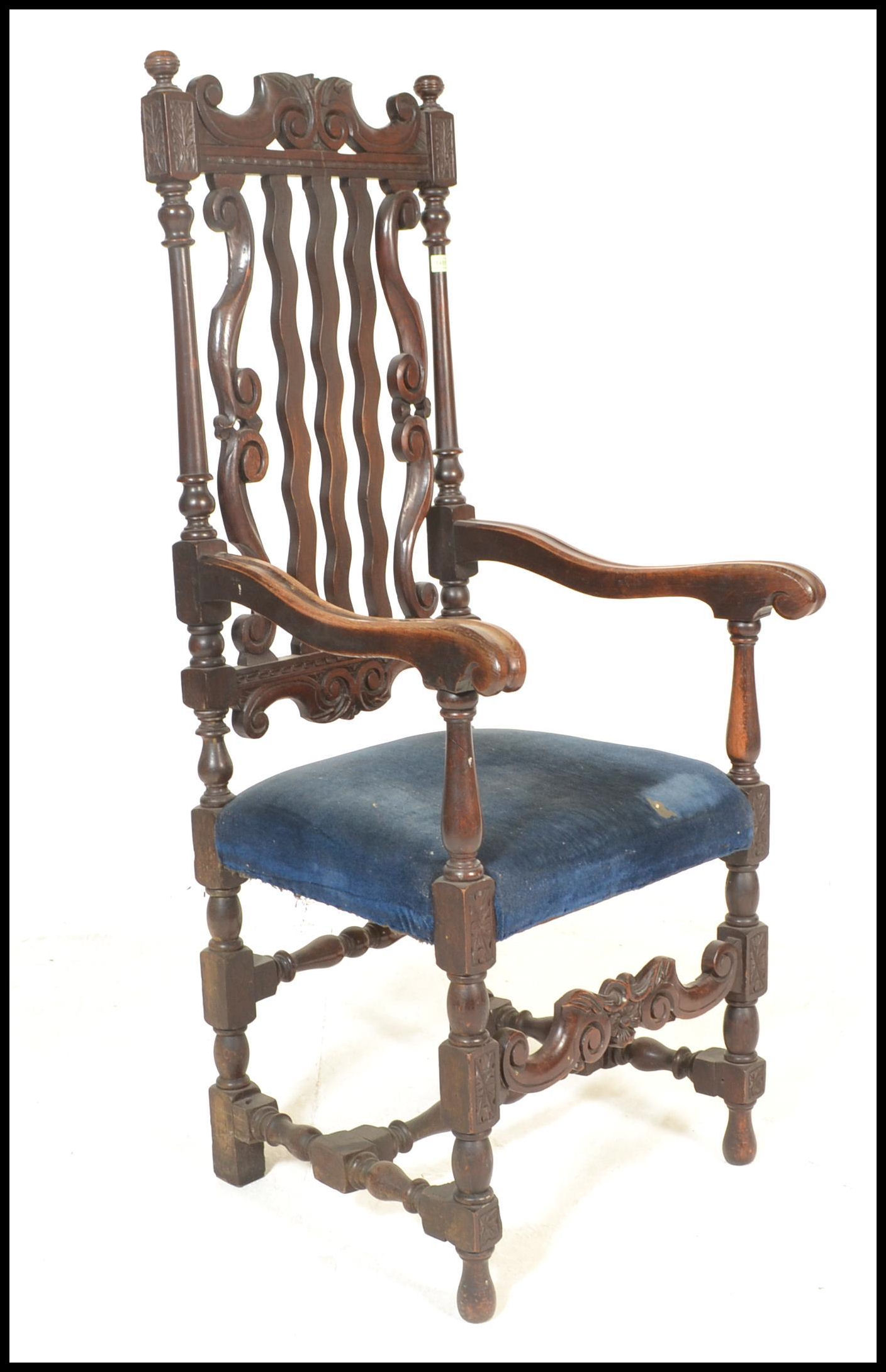 A 19th Century Victorian Carolean style carved oak arm chair, the cresting rail, with later