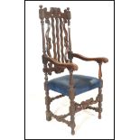 A 19th Century Victorian Carolean style carved oak arm chair, the cresting rail, with later