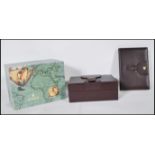 A vintage Rolex box upholstered in burgundy leather with a buckle design to the top, the interior