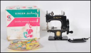 A vintage boxed Child's Singer Sewing machine model No. 20. Appears complete in box with