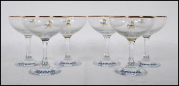 A set of six vintage retro 20th Century Babycham glasses raised on circular bases with gilt rim