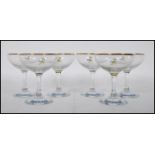 A set of six vintage retro 20th Century Babycham glasses raised on circular bases with gilt rim