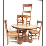A 20th Century large pine circular tavern style dining table and four chairs, the circular top on