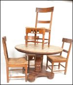 A 20th Century large pine circular tavern style dining table and four chairs, the circular top on