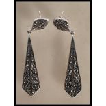 A pair of stamped 925 silver and marcasite Art Deco style drop earrings having textured backs. Gross