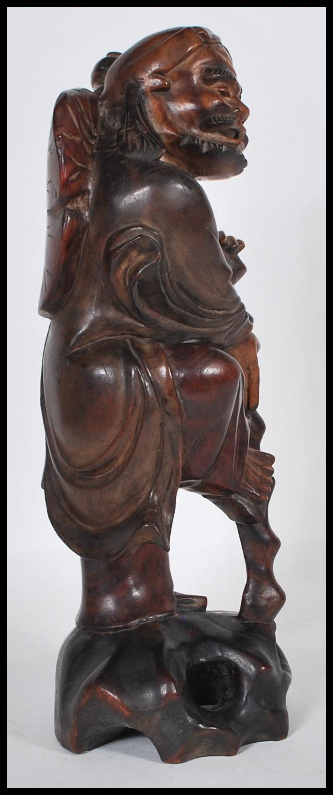 An early 20th Century Chinese carved hardwood figure of an Immortal holding a gnarled staff with one - Image 2 of 6