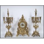 A 20th century French brass clock garniture, ornately decorated case moulded with scrolled leafage