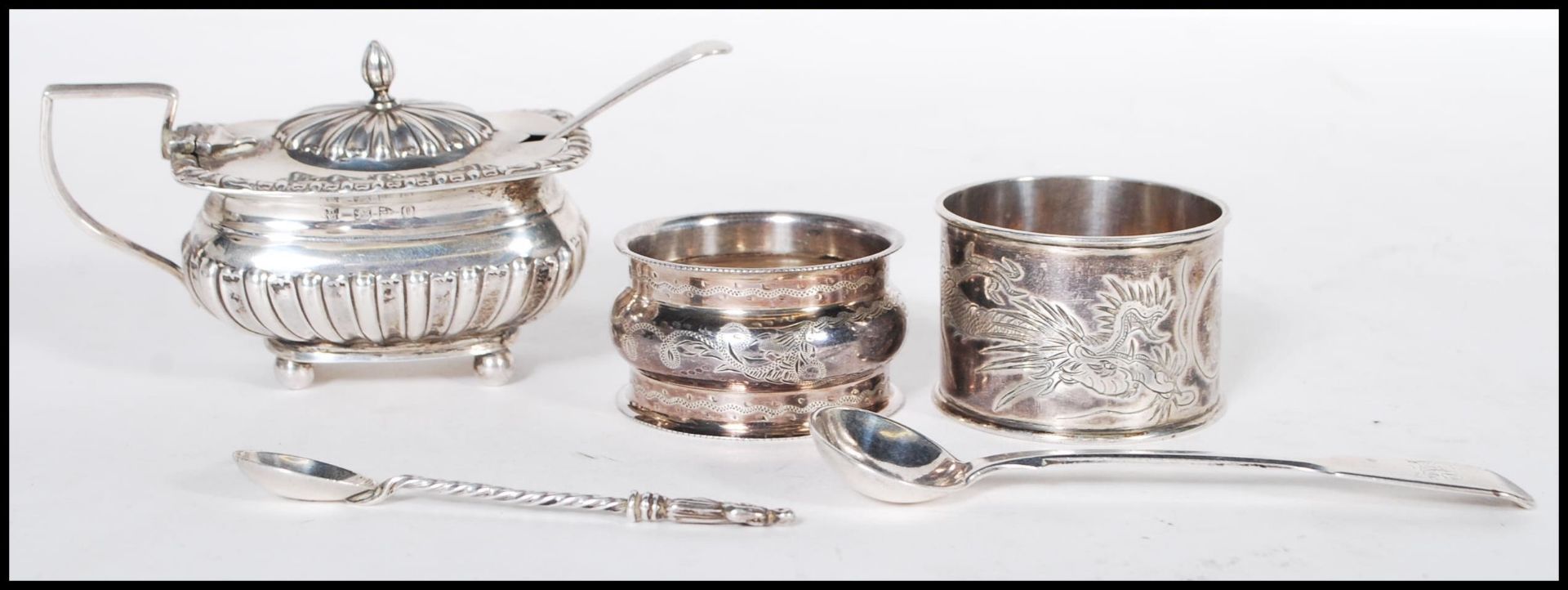 A selection of silver items, most having English hallmarks to include a mustard pot condiment having