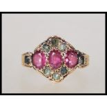 A 19th Century Victorian 15ct gold ring set with three oval cut pink stones flanked by green