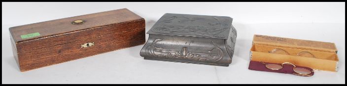 A collection of items to include; a vintage shaped and embossed chocolate tin, a vintage wooden