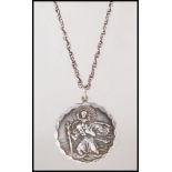 A silver English hallmarked medallion style pendant having a raised St Christopher design with an