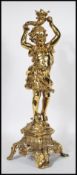 A late 19th / early 20th Century cast bronze candlestick modelled as a young girl in the classical