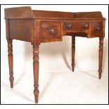 A 19th Century mahogany writing table desk, gallery surround to the flared top over three drawers