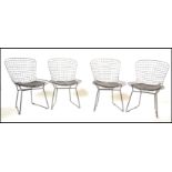 A set of four contemporary side chairs / dining chairs in the manner of Harry Bertoia 420C chairs.