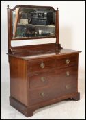 An early 20th Century mahogany dressing chest, swing mirror atop over flared top with three