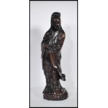 A 20th Century carved hardwood Chinese Kwan Yin figure having silver inlaid decoration, depicted