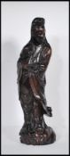 A 20th Century carved hardwood Chinese Kwan Yin figure having silver inlaid decoration, depicted