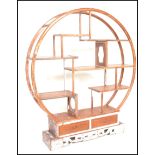 A 20th Century Chinese hardwood distressed etagere display room unit divider of circular form having