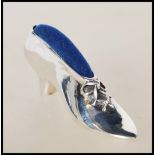 A stamped 925 silver pin cushion in the form of a Victorian shoe having a blue velvet top. Stamped