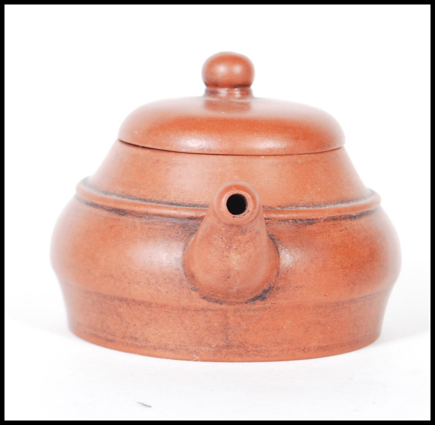 An early 20th Century Chinese Yixing teapot modelled in a brown clay with shaped handle and spout. - Image 2 of 7