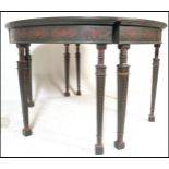 A pair of 20th Century ebonised wood demi lune D end tables having stencilled ochre decoration