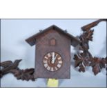 A mid-20th century black forest style wall cuckoo clock. Carved wooden surround, with deer and