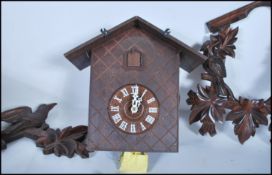 A mid-20th century black forest style wall cuckoo clock. Carved wooden surround, with deer and